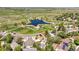 Aerial view of a community with walking paths, green spaces, and a lovely pond at 3298 W 11Th Avenue Pl, Broomfield, CO 80020