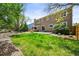Spacious backyard with lush lawn, patio area, and mature trees offers a tranquil retreat at 3298 W 11Th Avenue Pl, Broomfield, CO 80020