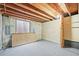 Unfinished basement with concrete walls, a window, carpeted area, and exposed ceiling at 3298 W 11Th Avenue Pl, Broomfield, CO 80020