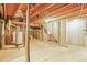 Basement with exposed wood beams, utilities, and concrete flooring, ready for finishing at 3298 W 11Th Avenue Pl, Broomfield, CO 80020
