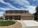 Charming two-story home featuring a manicured lawn, complemented by solar panels and an attached two-car garage at 3298 W 11Th Avenue Pl, Broomfield, CO 80020