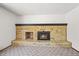 Close-up of brick fireplace in the living room with lit fire and neutral carpet at 3298 W 11Th Avenue Pl, Broomfield, CO 80020