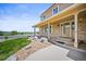 Welcoming covered front porch with brick columns and stone landscaping accents at 3298 W 11Th Avenue Pl, Broomfield, CO 80020