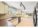 Cozy kitchen with updated track lighting and a view to the fireplace living room at 3298 W 11Th Avenue Pl, Broomfield, CO 80020