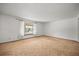 Vacant living room featuring neutral carpet, a large window and natural light at 3298 W 11Th Avenue Pl, Broomfield, CO 80020