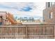 View from backyard over fence; city skyline visible at 2512 Kensing Ct, Denver, CO 80211