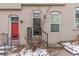 Tan colored building with red and dark brown doors, steps and small front yard at 2512 Kensing Ct, Denver, CO 80211