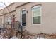 Two-story building with dark brown door and metal railing at 2512 Kensing Ct, Denver, CO 80211