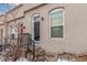 Tan colored building with red and dark brown doors, steps and small front yard at 2512 Kensing Ct, Denver, CO 80211