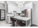 Modern kitchen with white shaker cabinets, marble countertops, and stainless appliances at 2512 Kensing Ct, Denver, CO 80211