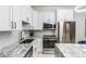Modern kitchen with stainless steel appliances and marble countertops at 2512 Kensing Ct, Denver, CO 80211