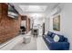 Open living area with exposed brick wall, modern kitchen, and comfortable seating at 2512 Kensing Ct, Denver, CO 80211