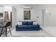 Blue couch and kitchen with marble countertops and stainless steel appliances at 2512 Kensing Ct, Denver, CO 80211