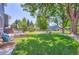 Lush backyard showing a deck, mature trees, and a well-maintained lawn, perfect for outdoor enjoyment at 1201 Trout Creek Cir, Longmont, CO 80504