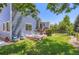 Spacious backyard features a deck, patio furniture and a lush green lawn for outdoor enjoyment at 1201 Trout Creek Cir, Longmont, CO 80504
