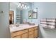 Well-lit bathroom features a large mirror, vanity with sink, and towel rack at 1201 Trout Creek Cir, Longmont, CO 80504