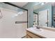 Clean bathroom featuring a glass-enclosed shower, vanity with sink, and medicine cabinet at 1201 Trout Creek Cir, Longmont, CO 80504