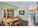 Traditional dining room featuring a wood table, decorative curtains, hutch, and hardwood floors with view to living area at 1201 Trout Creek Cir, Longmont, CO 80504