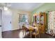 Traditional dining room featuring a wood table, decorative curtains, hutch, and hardwood floors for Gathering gatherings at 1201 Trout Creek Cir, Longmont, CO 80504