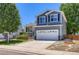 Two-story home featuring a lush green lawn, well-maintained garden, and two car garage in a suburban neighborhood at 1201 Trout Creek Cir, Longmont, CO 80504
