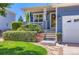 Charming front porch with decorative details, including a wreath, plants, and landscaping. Located in suburban neighborhood at 1201 Trout Creek Cir, Longmont, CO 80504