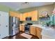 Bright kitchen features stainless steel appliances, sleek countertops, light wood cabinets, and hardwood floors at 1201 Trout Creek Cir, Longmont, CO 80504