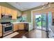 Bright kitchen features stainless steel appliances, sleek countertops, and hardwood floors with sliding door access to outside at 1201 Trout Creek Cir, Longmont, CO 80504