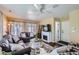 Bright living room featuring a fireplace, ceiling fan, and a large window for lots of natural light at 1201 Trout Creek Cir, Longmont, CO 80504