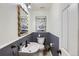 Stylish half-bathroom featuring modern fixtures, an elegant mirror, and updated wall decor at 1201 Trout Creek Cir, Longmont, CO 80504