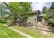 Backyard featuring a split rail fence, picnic table and lush landscaping at 4 Oakmont Ln, Littleton, CO 80127