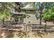 Backyard featuring a split rail fence, picnic table and lush landscaping at 4 Oakmont Ln, Littleton, CO 80127