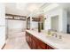 Well-lit bathroom features a large vanity with double sinks, a soaking tub, and a glass-enclosed shower at 4 Oakmont Ln, Littleton, CO 80127