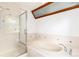 Bright bathroom featuring a large tub and a walk-in shower at 4 Oakmont Ln, Littleton, CO 80127
