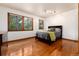Bedroom with hardwood floors, two windows, and modern track lighting at 4 Oakmont Ln, Littleton, CO 80127