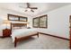 Bedroom featuring carpeted floors, natural light from wood-framed windows, and a ceiling fan at 4 Oakmont Ln, Littleton, CO 80127