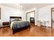 Bedroom featuring hardwood floors, a mirrored closet, and a work desk at 4 Oakmont Ln, Littleton, CO 80127