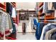Spacious walk-in closet with custom wood shelving and ample storage for shoes and clothing at 4 Oakmont Ln, Littleton, CO 80127