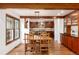 Open layout dining space with wood floors and cabinetry, seamlessly connected to the kitchen at 4 Oakmont Ln, Littleton, CO 80127