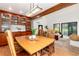 Cozy dining room seamlessly connecting to a living room, bathed in natural light from the surrounding windows at 4 Oakmont Ln, Littleton, CO 80127