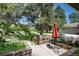 Cozy front patio with outdoor seating, a small table, and a landscaped garden at 4 Oakmont Ln, Littleton, CO 80127