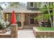 Inviting front porch with brick columns, a seating area, and well-maintained landscaping at 4 Oakmont Ln, Littleton, CO 80127