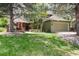 Charming two-story home with landscaped front yard, brick accents, and a cozy outdoor seating area at 4 Oakmont Ln, Littleton, CO 80127