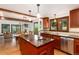Open kitchen with stainless steel appliances, a large island, and hardwood floors at 4 Oakmont Ln, Littleton, CO 80127