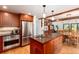 Well-equipped kitchen with stainless steel appliances, a large island, and hardwood floors at 4 Oakmont Ln, Littleton, CO 80127