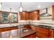 Modern kitchen with cherry wood cabinetry, stainless steel appliances, and granite countertops at 4 Oakmont Ln, Littleton, CO 80127