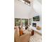 Bright living room with high ceiling, fireplace, comfortable seating, and a serene view at 4 Oakmont Ln, Littleton, CO 80127