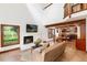 Comfortable living room features a fireplace, large windows, and an open layout with views into the kitchen at 4 Oakmont Ln, Littleton, CO 80127