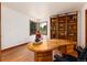 Office space with a curved wood desk, large windows with views, and a bookshelf for storage at 4 Oakmont Ln, Littleton, CO 80127