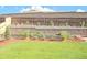 Backyard featuring a landscaped retaining wall and a large green lawn at 892 High Point Trl, Elizabeth, CO 80107