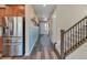 Inviting entryway featuring wood floors, staircase, and stylish blue accent wall at 892 High Point Trl, Elizabeth, CO 80107